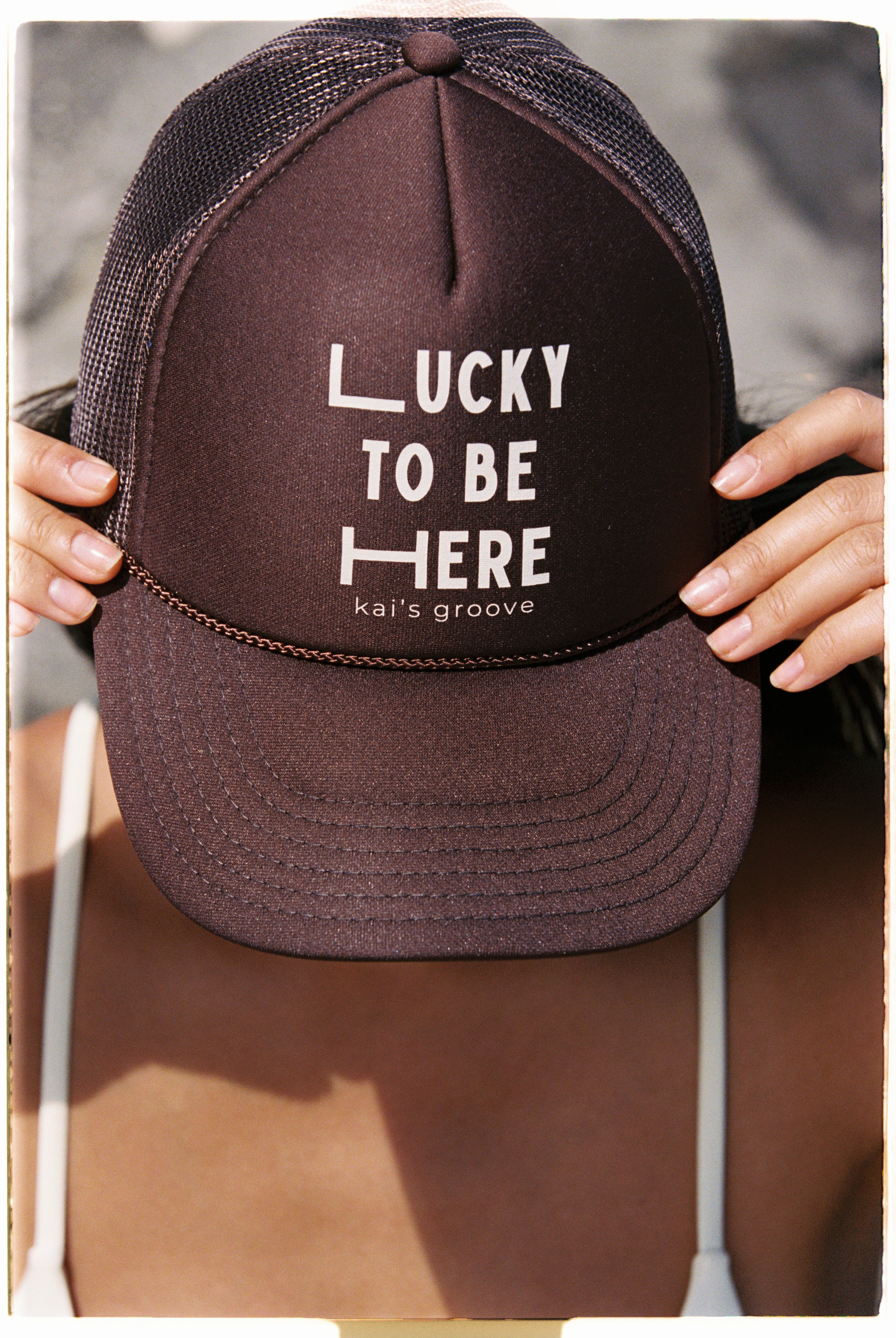 LUCKY TO BE HERE brown trucker hat